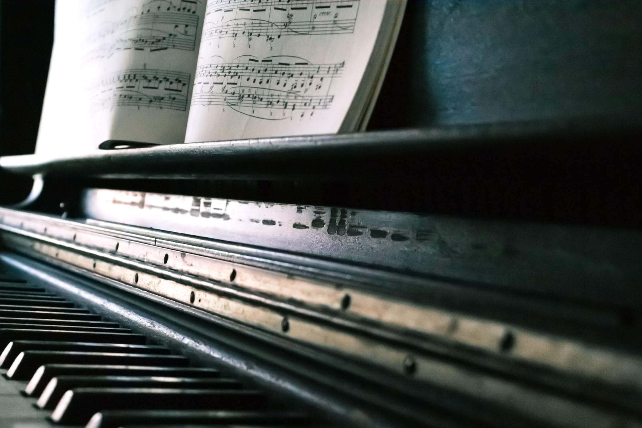 close up picture of piano with sheet music