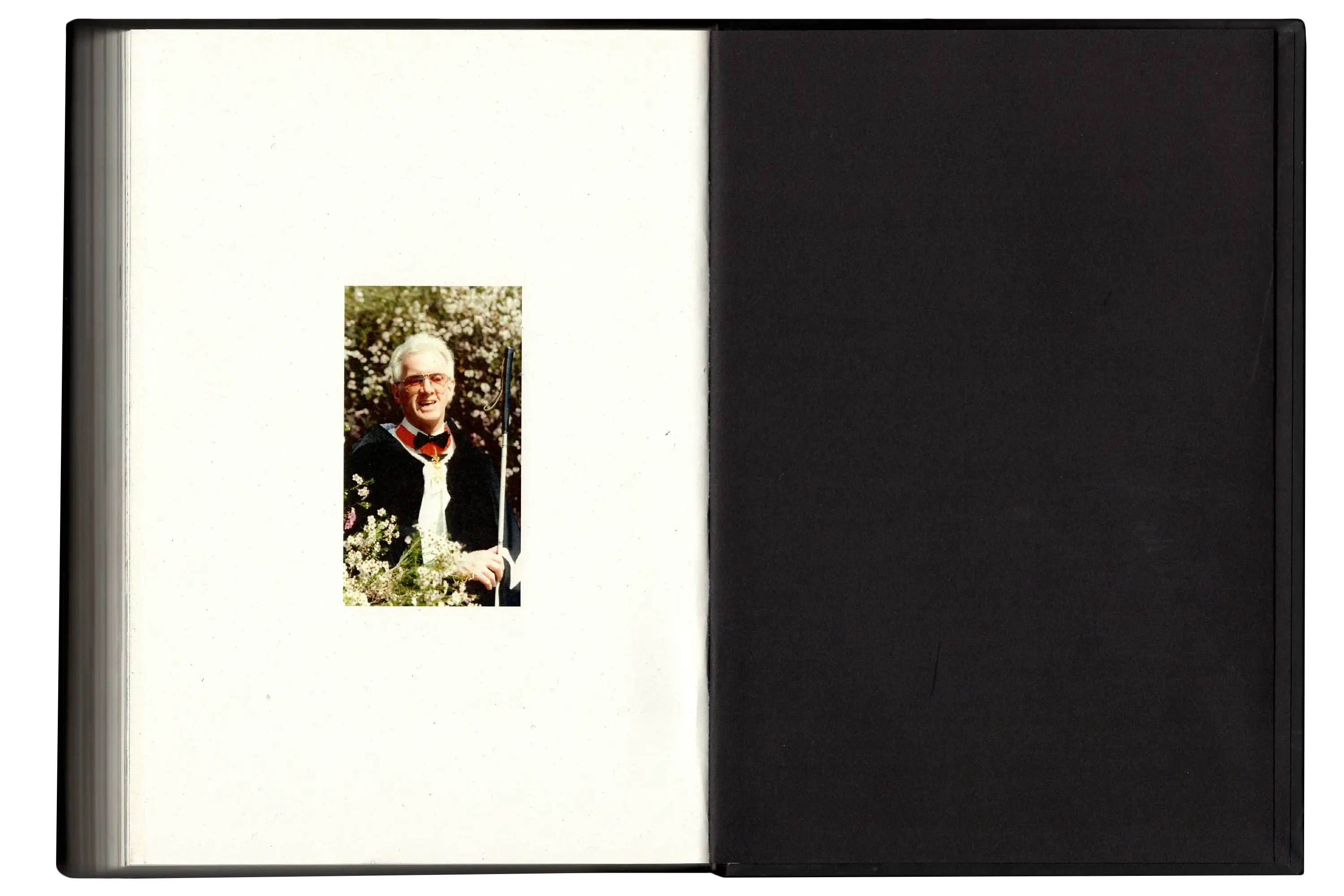 Imperfect Photo Book - left page small photo of blind pop Graham Laycock, right page is a blank black page