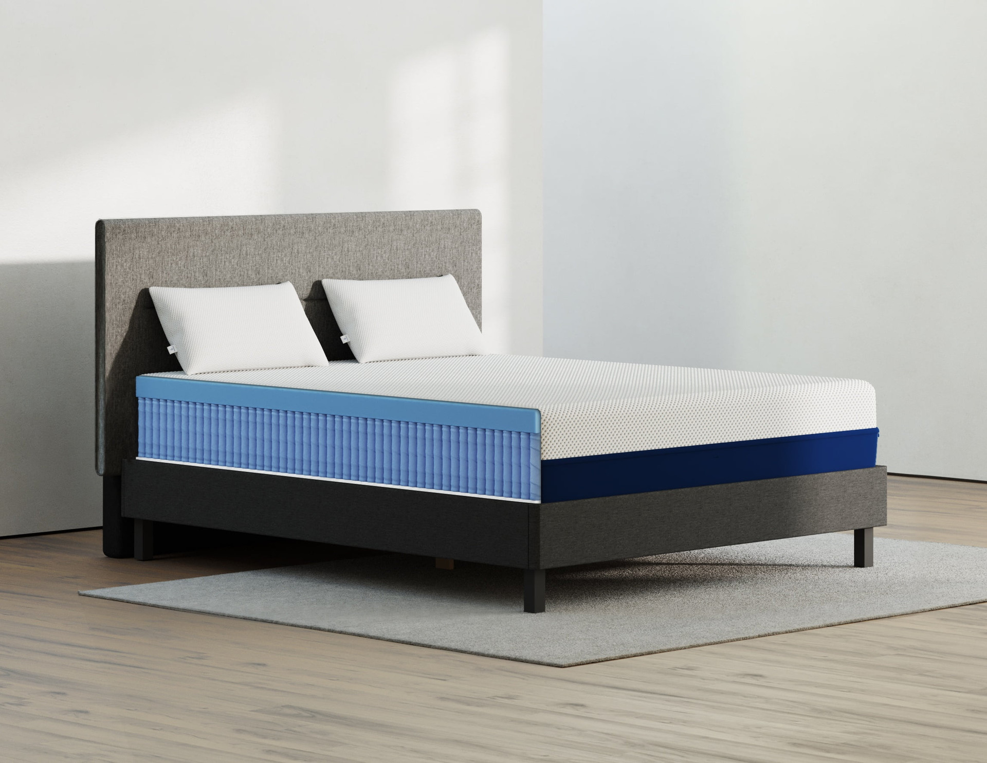 Amerisleep bed with blue layers appearing and two pillows over the bed