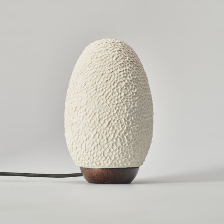 Egg-shaped textured lamp, showing the whiteness of the porcelain when it is switched off.