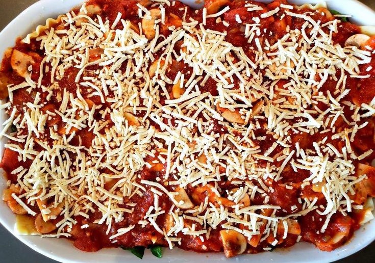 Casserole dish with lasanga topped with vegan cheese