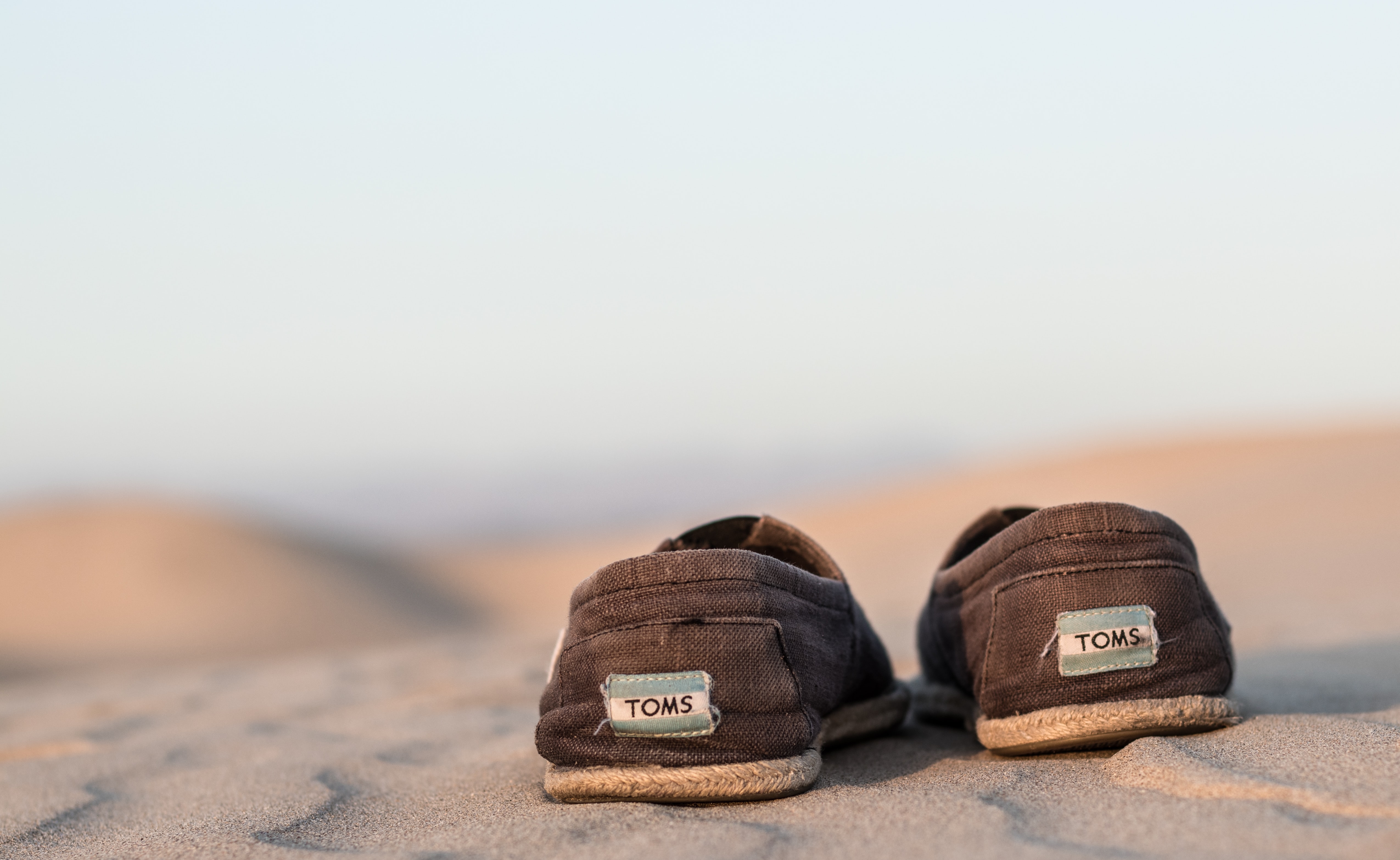 A pair of Toms shoes in the desert.