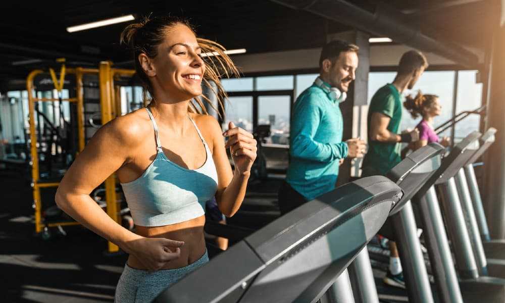 People working out on a treadmill during a September gym promotion.