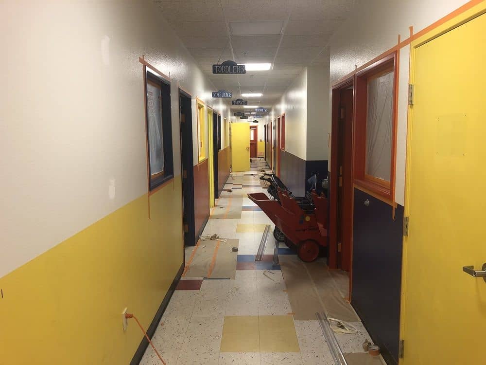 enlarged photo of long hallways of a half finished commercial painting job