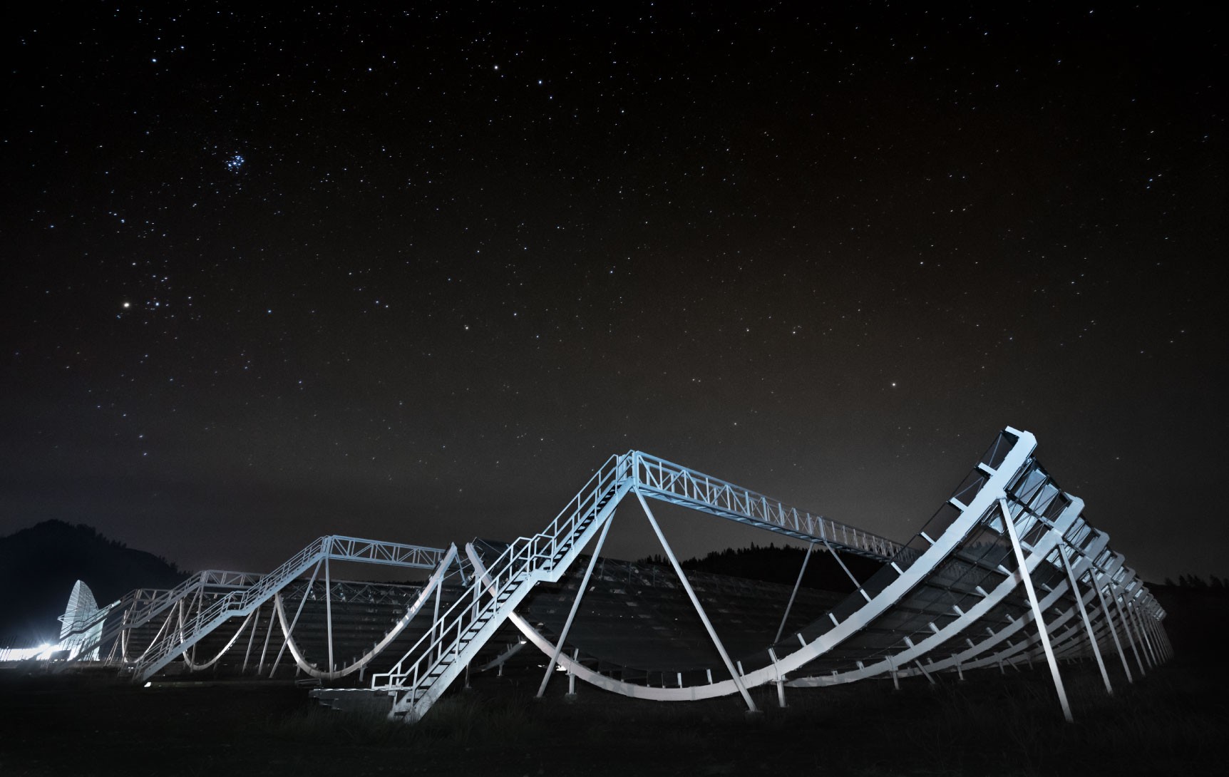 CHIME, a radio telescope, maps the universe under a starry night sky