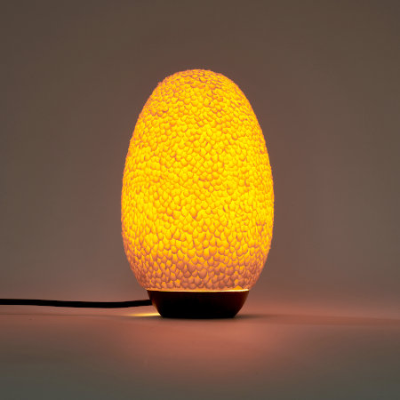 Egg-shaped textured lamp, with the light switched on.