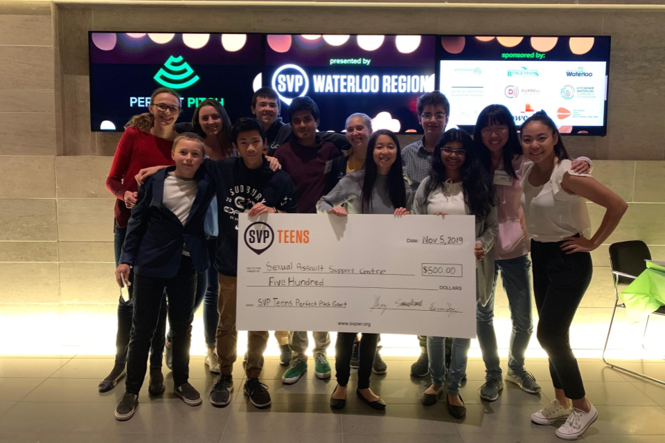 Group photo with a large check