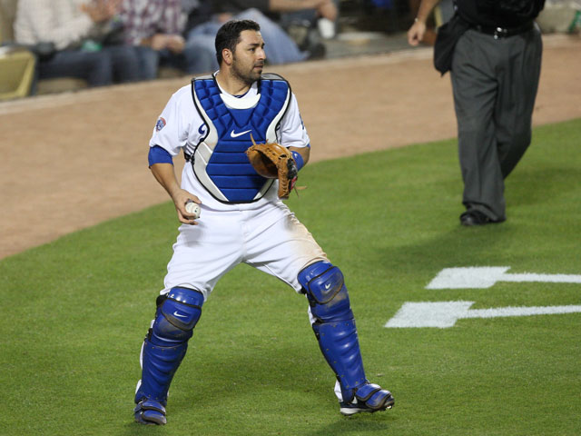 MLB Catcher Rod Barajas chases a wild throw with his mask off