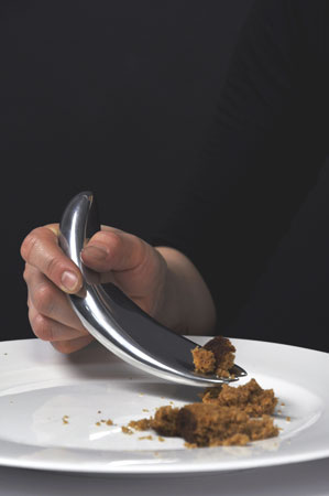 another close up of a proto-spoon in use, with a wider, curved structure all the way through, for easy scooping