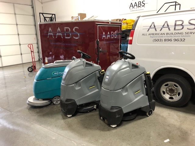 commercial floor polishers in warehouse.