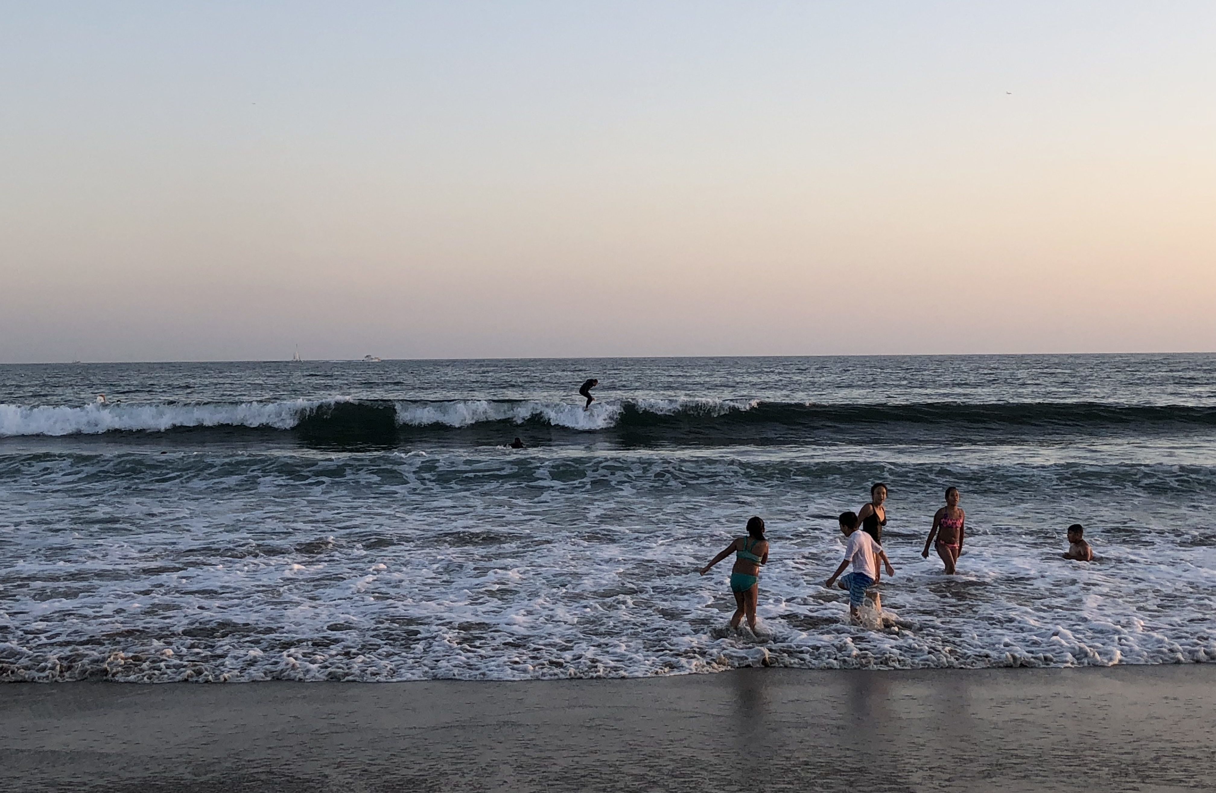 kids swimming at sunset