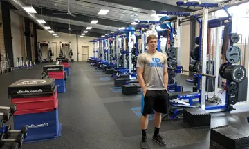 Showing off the newly built weightroom at the University of Dubuque.