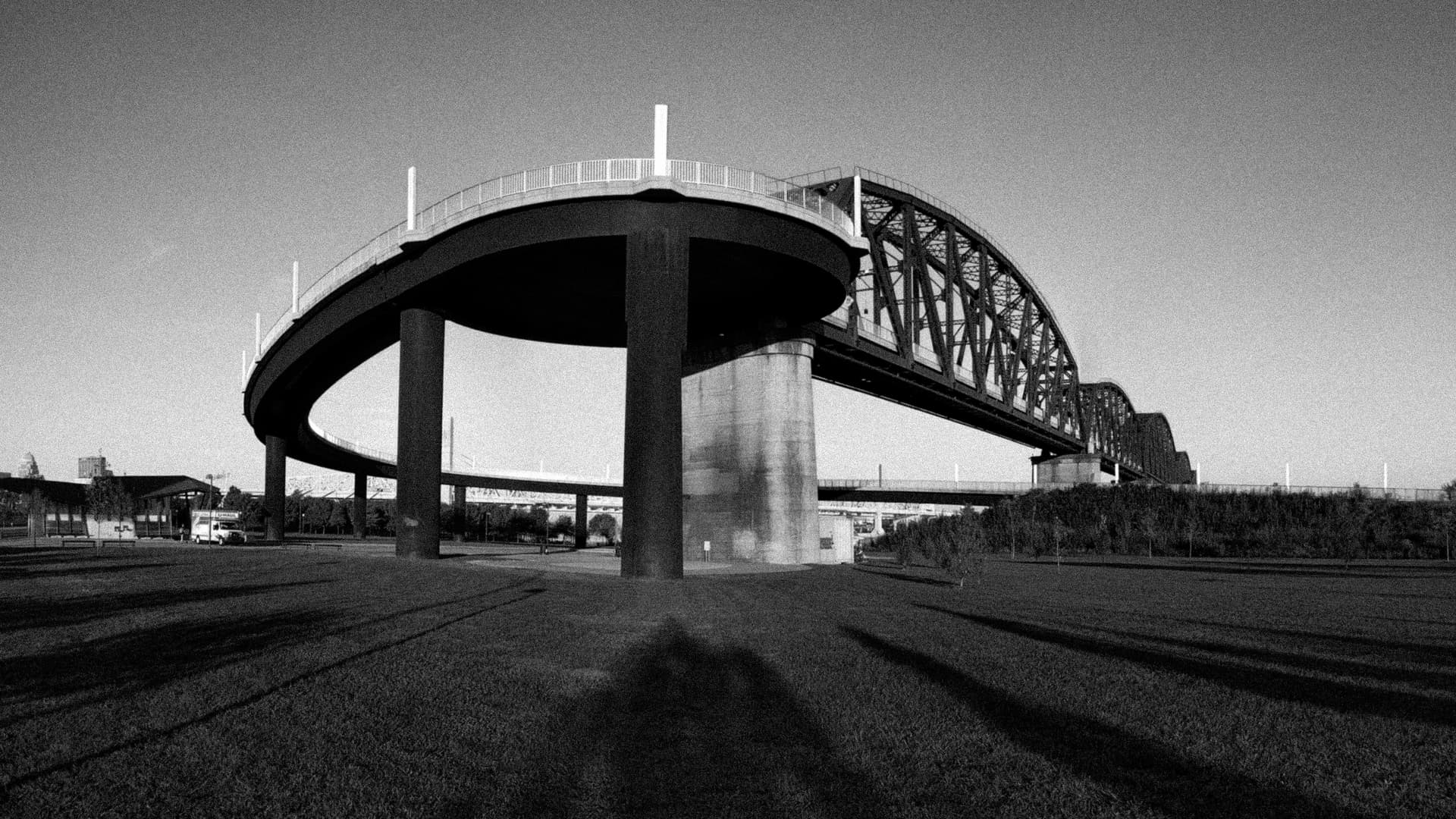 The spiral pedestrian ramp leading on to a steel footbridge crossing the Ohio River.
