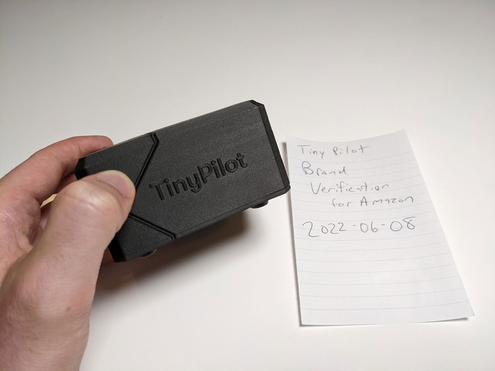 Photo of me holding a TinyPilot Voyager 2 with a dated note to Amazon