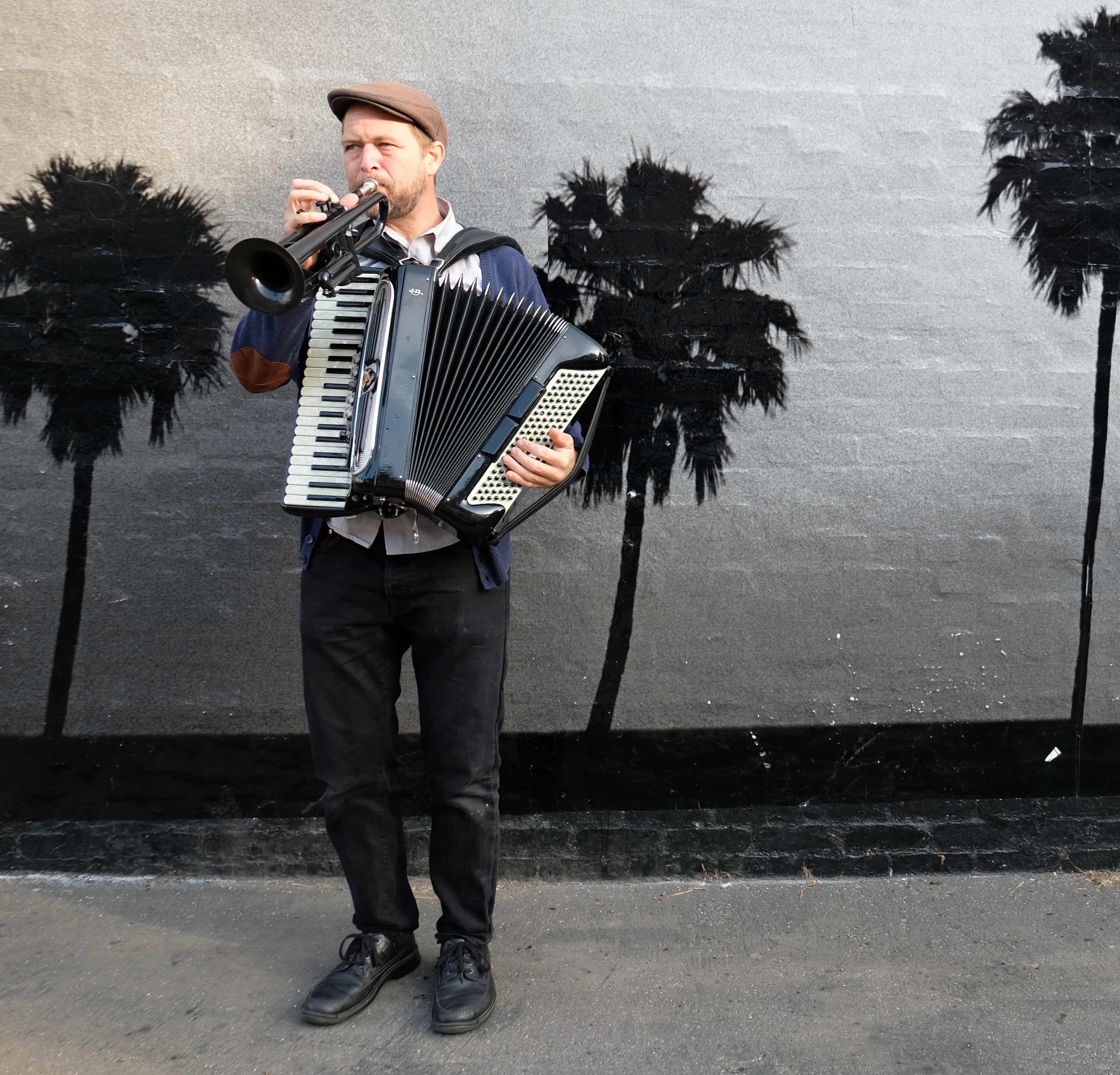 Musician Michael playing accordion and trumpet