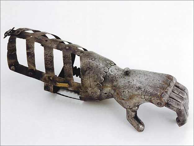 An iron hand from the 16th century. A latticed brace connects it to the user's forearm, and a hinged metal hand has simple grasping capacity