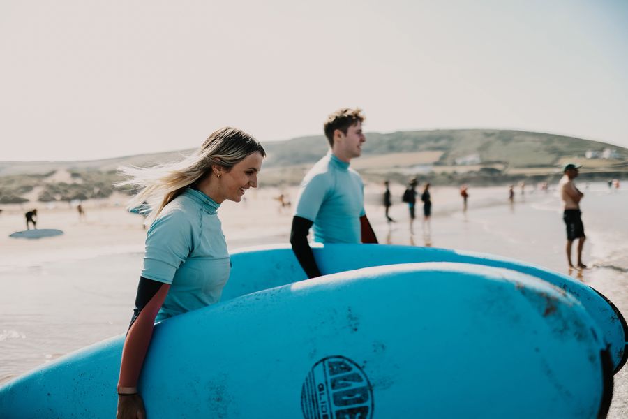 man and women with surf boards