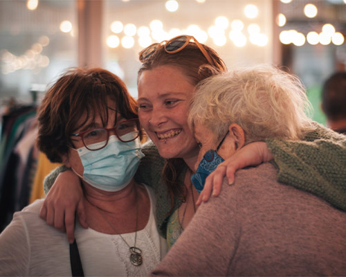 The owner Laura Rainbird hugging two people