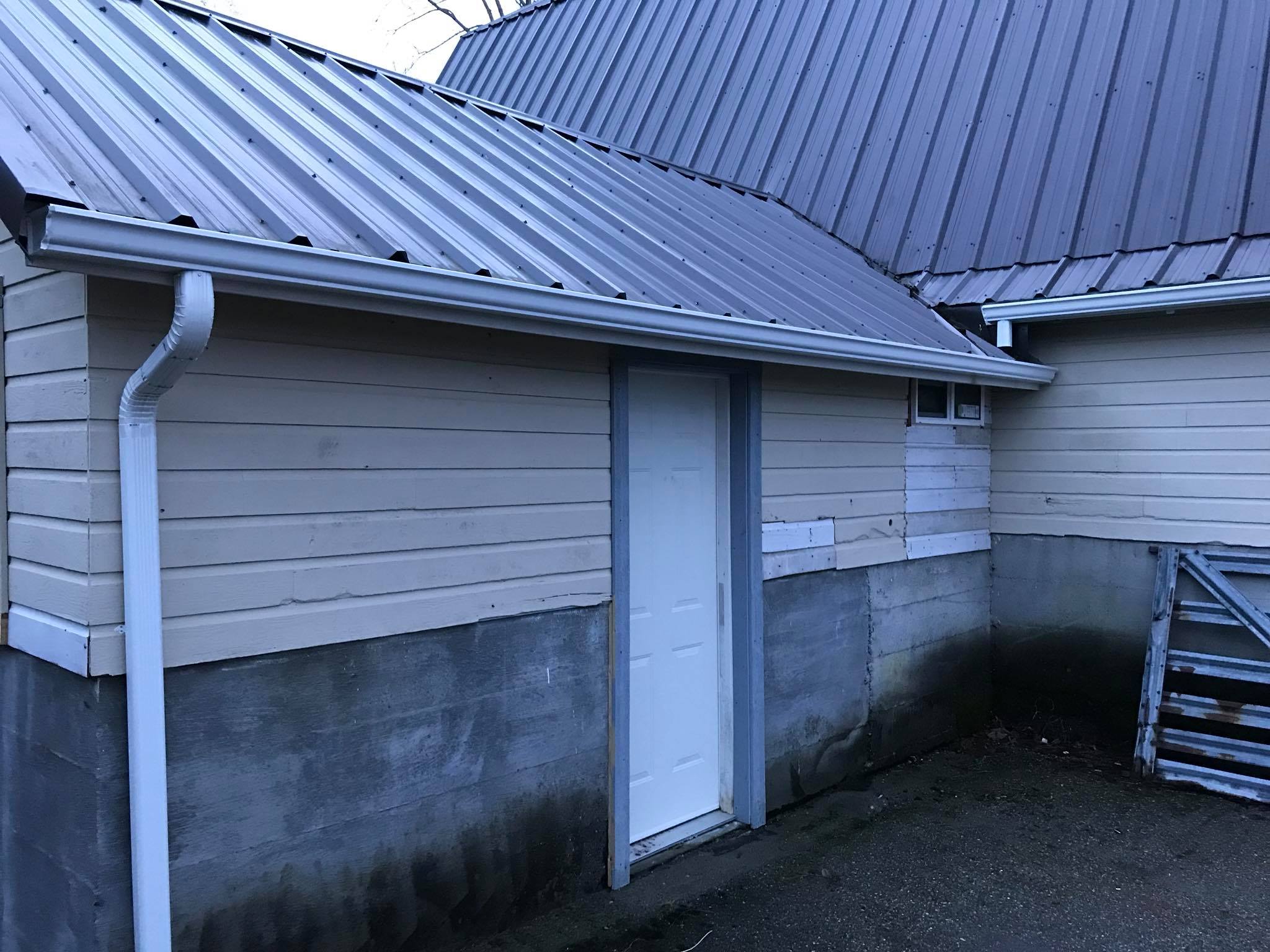 side angle new gutter installtion on a yellow and stone home