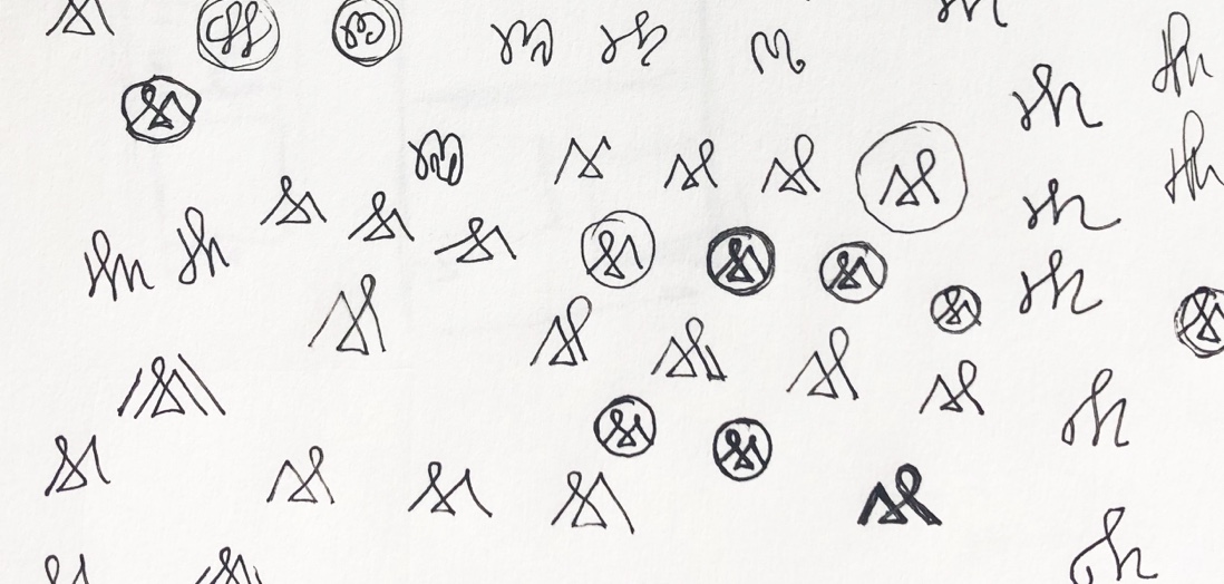 Page from notebook with logo sketches.