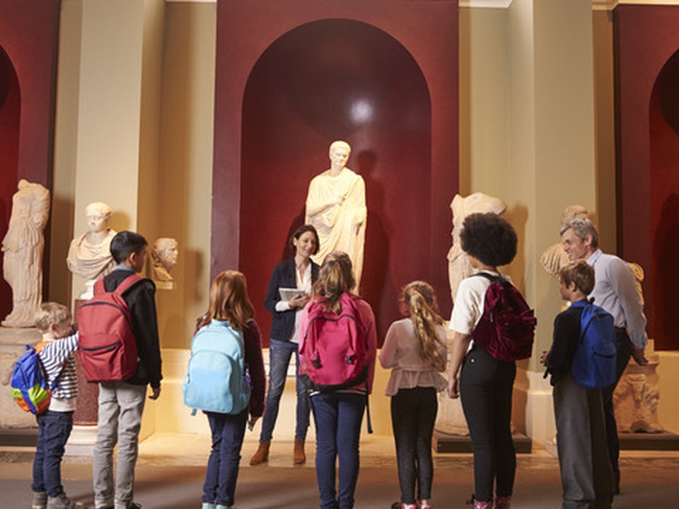 A group mixed of adult and children visiting a museum