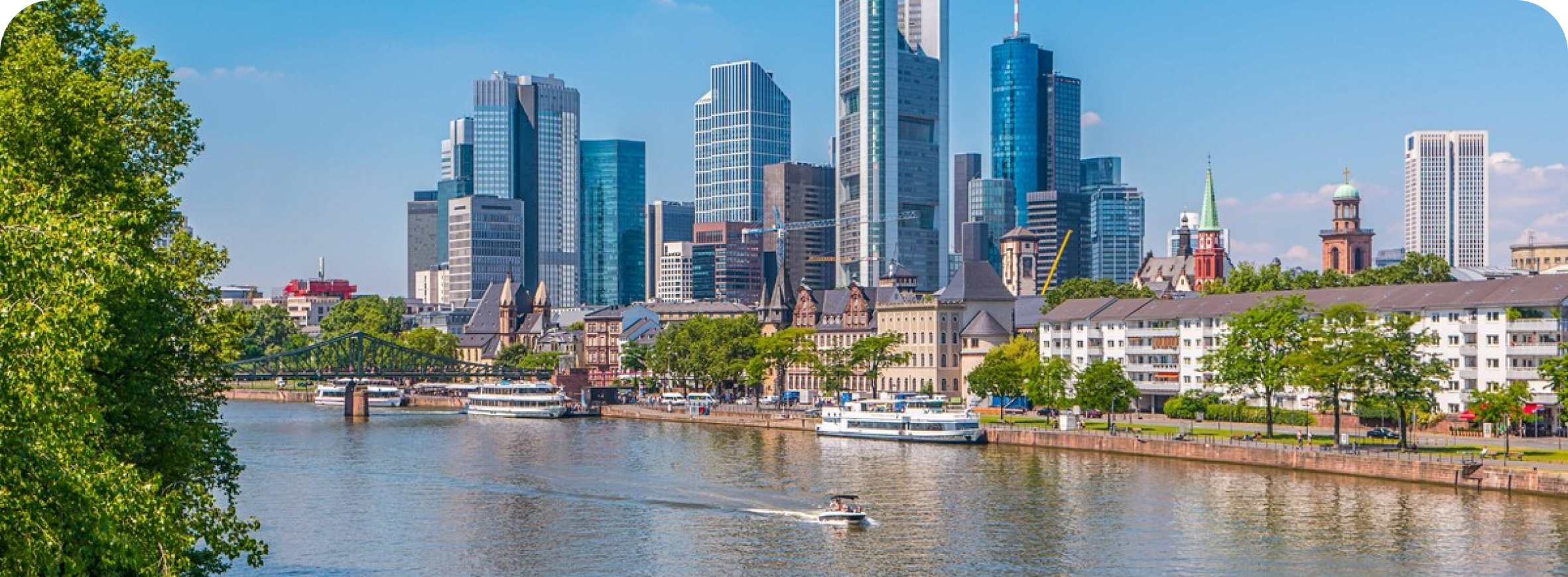 Suwag cover image of a vibrant city with blue sky, water and skyscrapers alongside a green and sunny landscape.