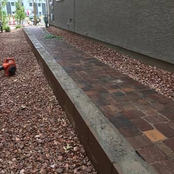 newly installed brick paved retaining wall
