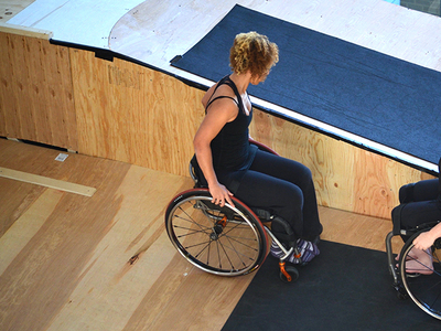 An aerial shot of students building a 24-foot square wooden ramp, a stage landscape for dancer/choreographer Alice Sheppard and her collaborator, Laurel Lawson.