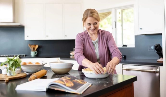 woman in kitchen baking a pie