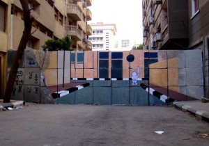 [A mural depicting Handala facing the Ministry of Interior]