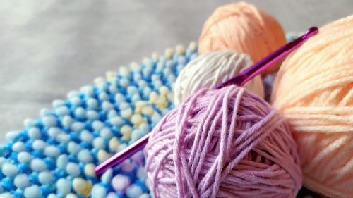 Thumbnail Balls of yarn and a knitting needle
