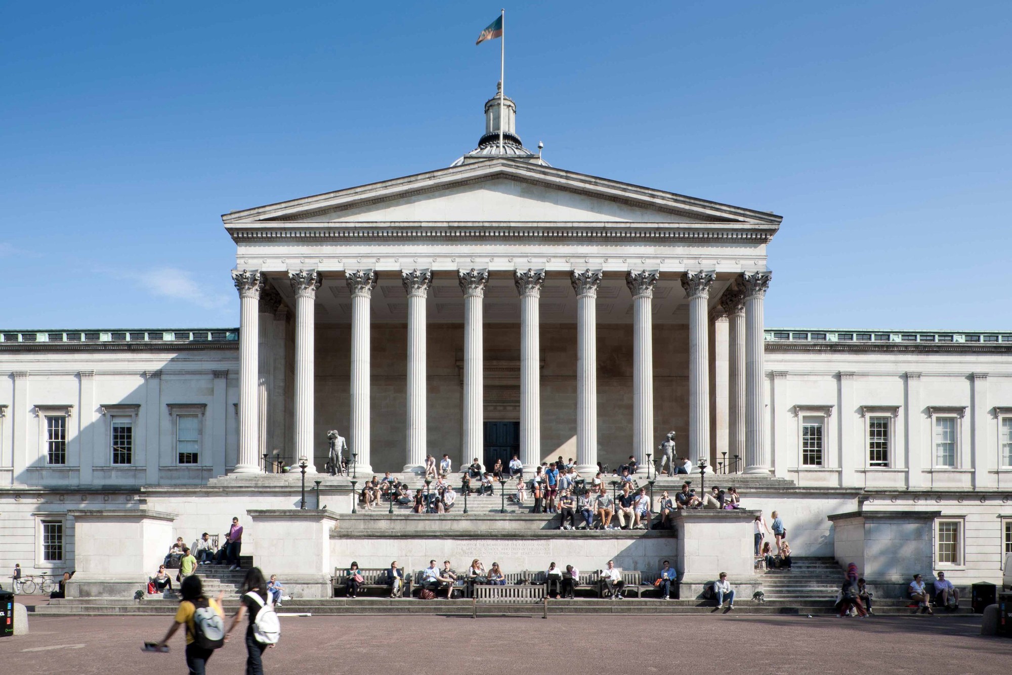 Students socializing and reading on the steps and quad at UCL's Main Building