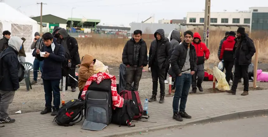 Refugees waiting to on the Polish side of the border with Ukraine following Russia's February 2022 invasion