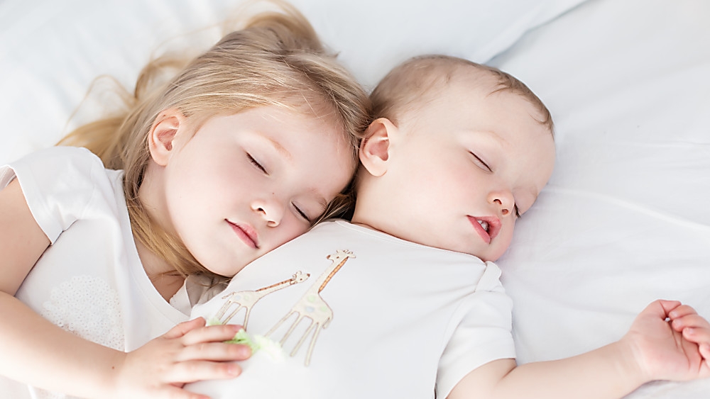 Sister and brother sleeping together