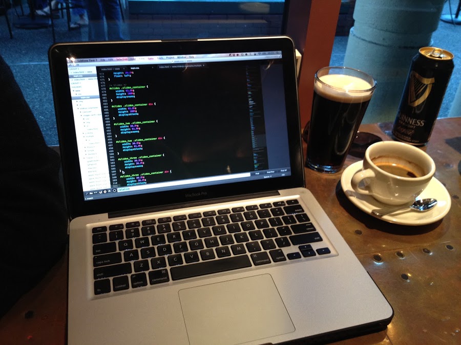 Hesap at a cafe, next to a Guinness and an espresso, with CSS open on screen in Sublime Text.