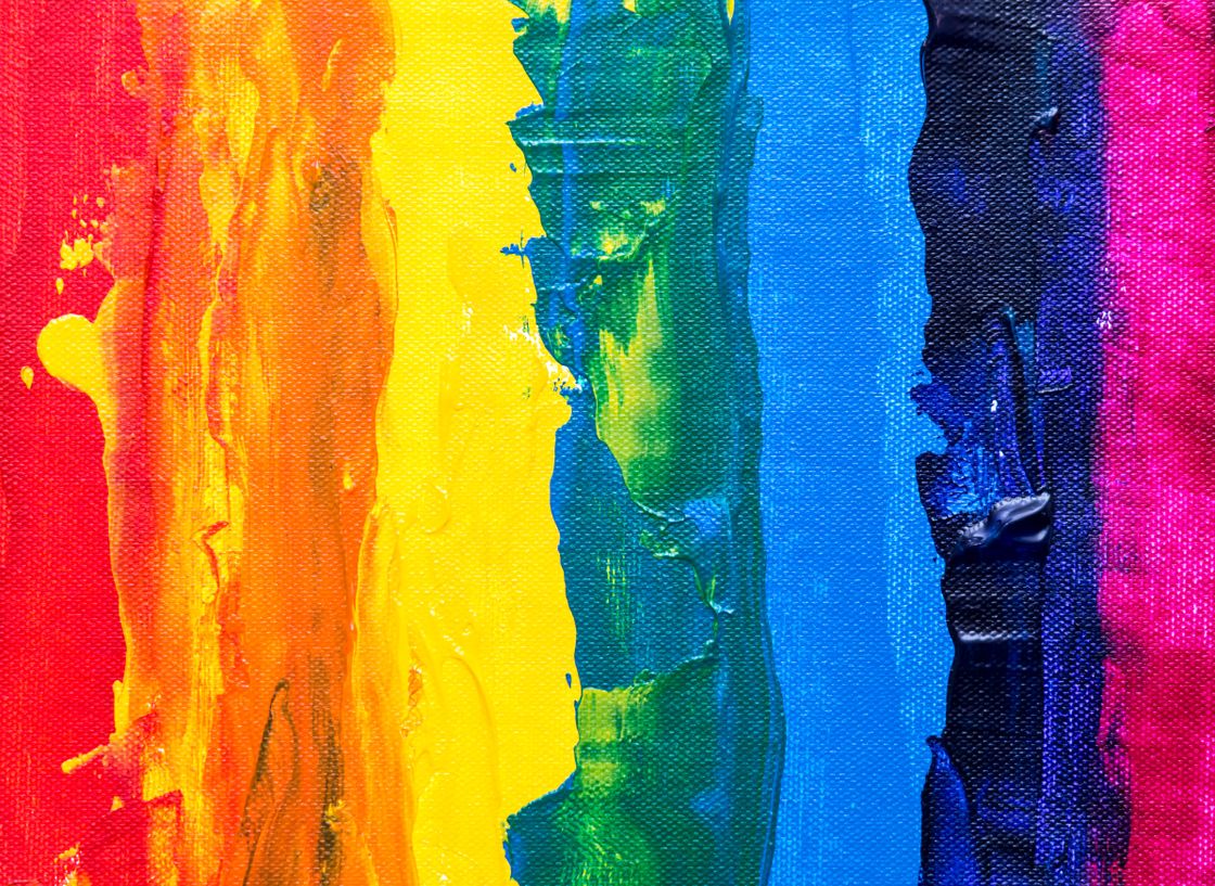 Abstract painting with colored stripes in hues of red, green, and blue from left to right forming a rainbow.