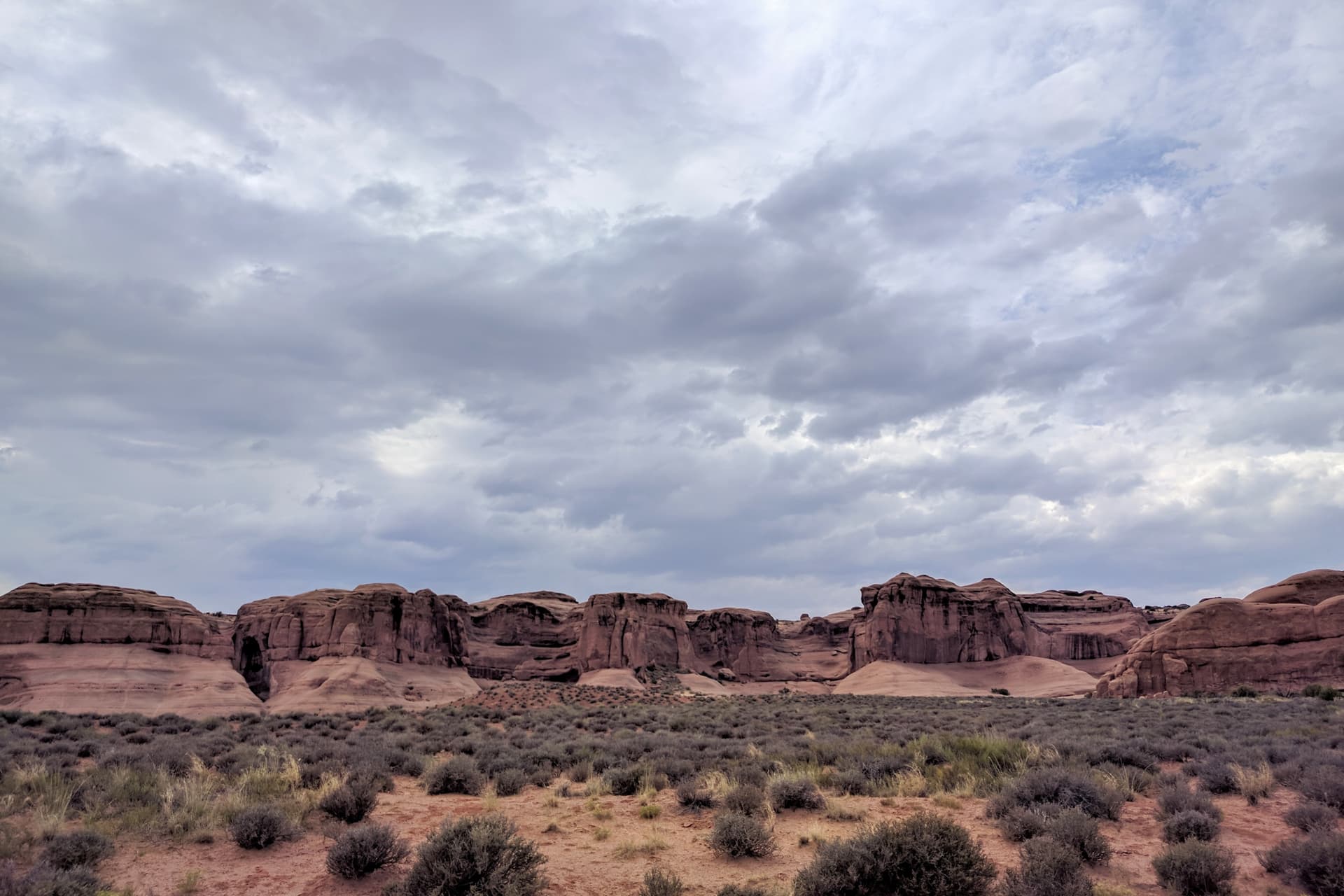 The undulating wall of a mesa near the entrance to Arches National Park.