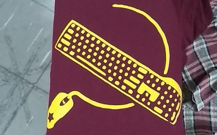 a keyboard and a mouse with it's wire alluding to the hammer and sickle sign