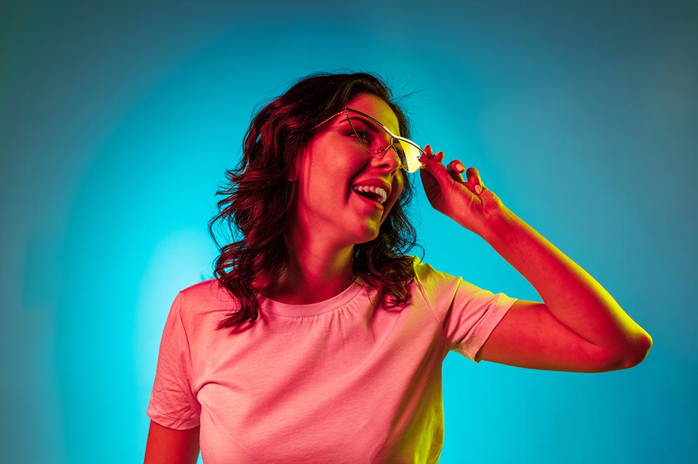 Lady with glasses smilling and looking to the right