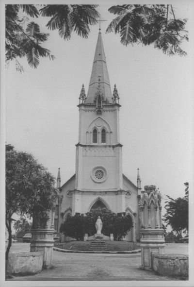 A black and white photo of the 152 feet-tall spire-topped tower of the Church of The Nativity of the Blessed Virgin Mary, located at Upper Serangoon Road.