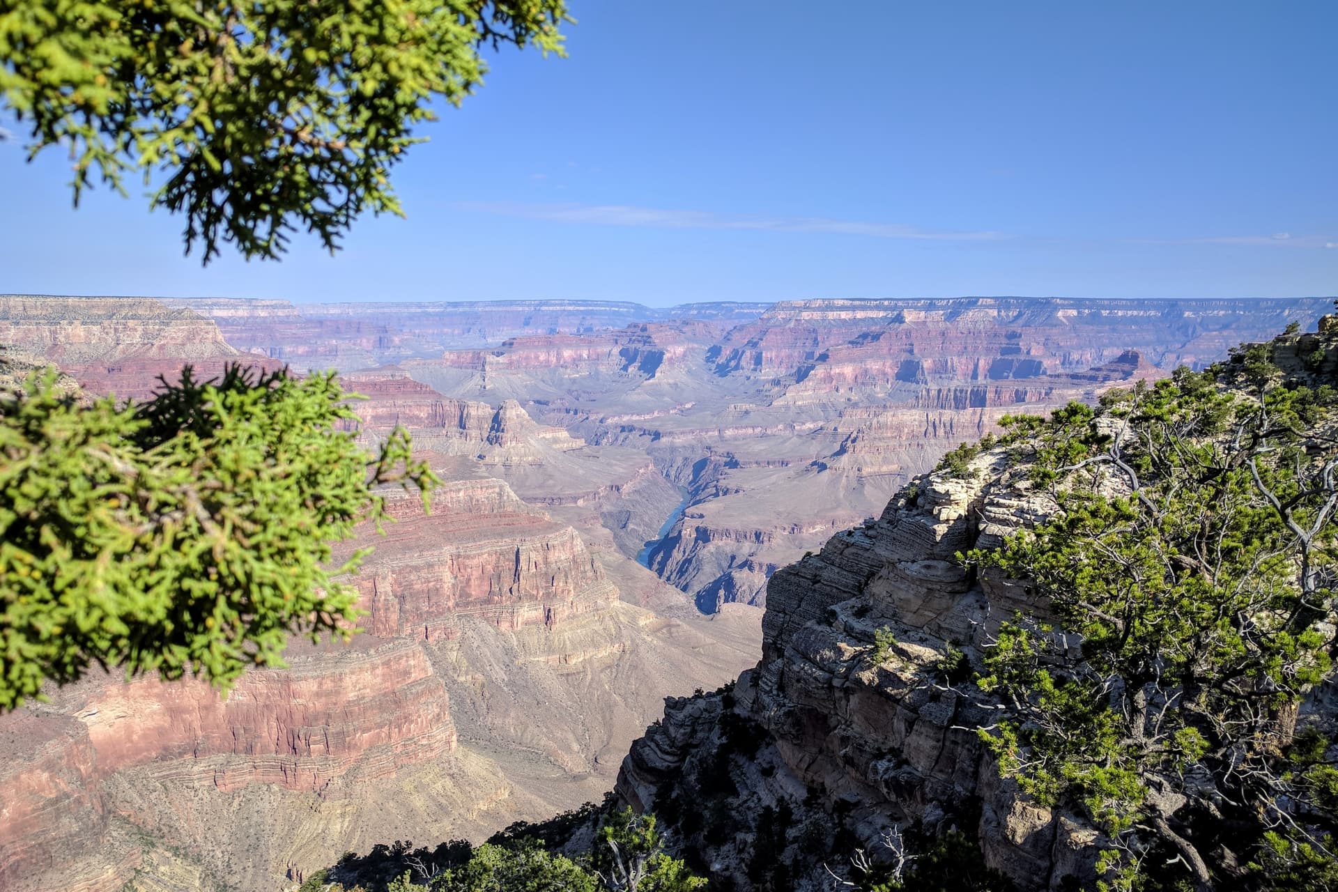 A view into the Grand Canyon from the South Rim. The Colorado River is barely visible in a steep gorge near the center of the Canyon.