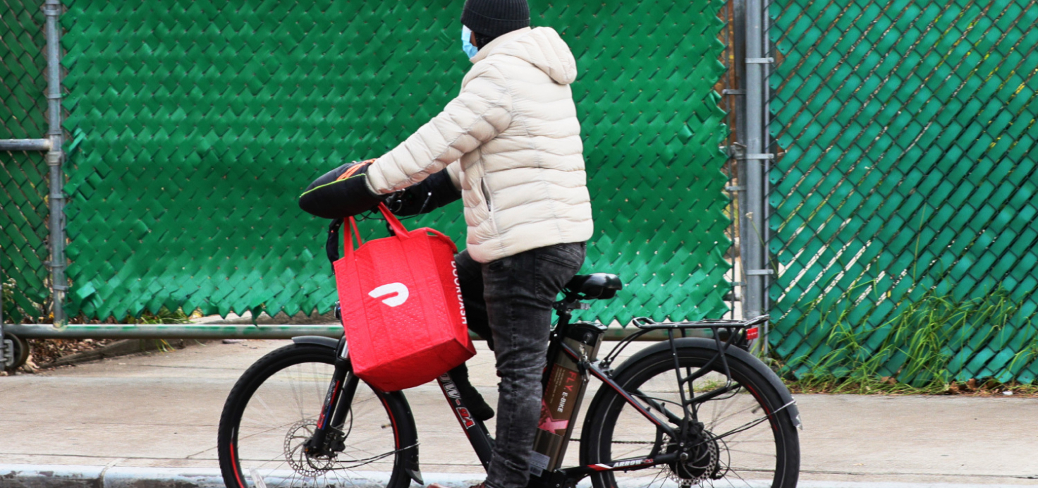 Image of a DoorDash working on a bicycle