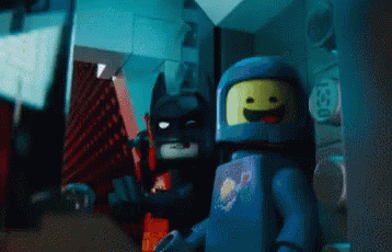 Lego batman throws knives at a button trying to press it. After several attempts he hits the button, and shouts 'First try!'