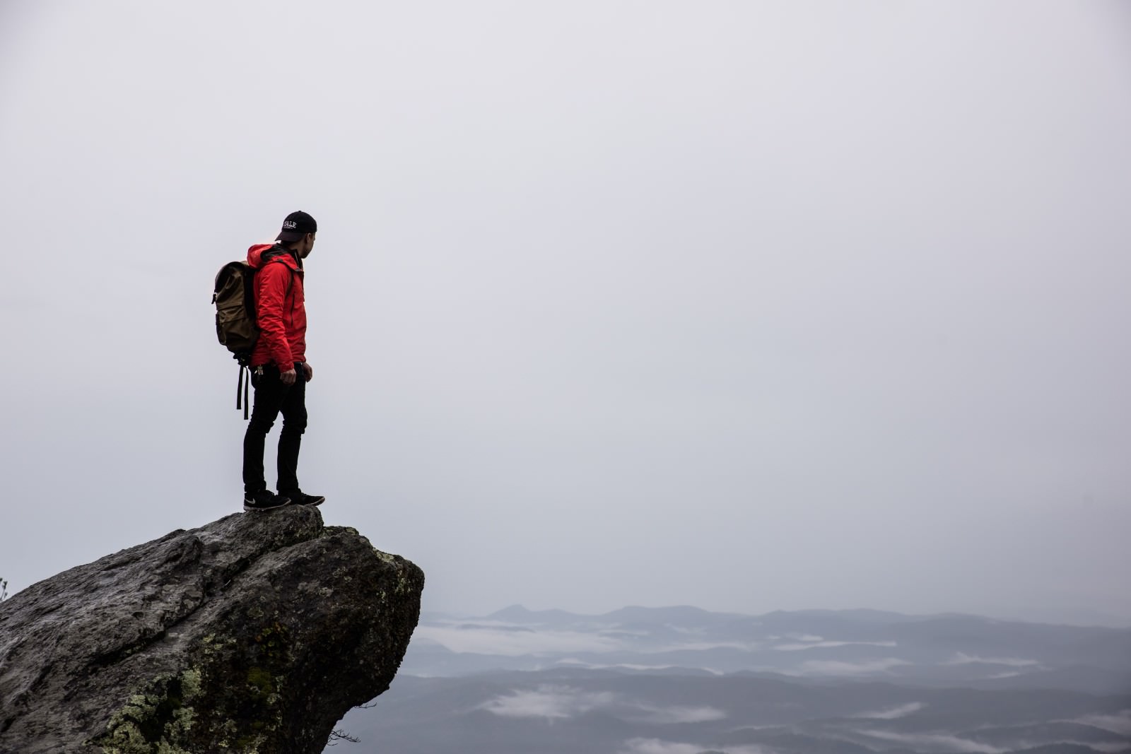 picture of man standing on a rock ledge