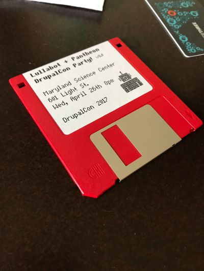 A red floppy drive sitting on a desk