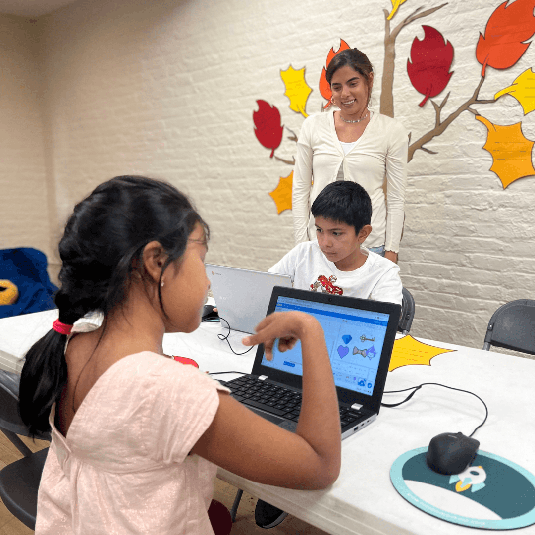 Kids coding in fall-themed room