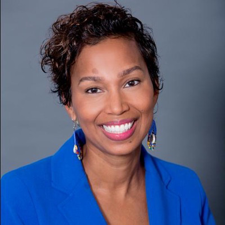 Professor Maurya Glaude - smiling and wearing a blue suit