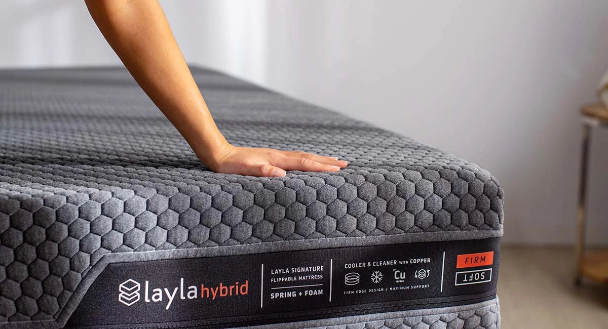 hand touching the layla hybrid mattress