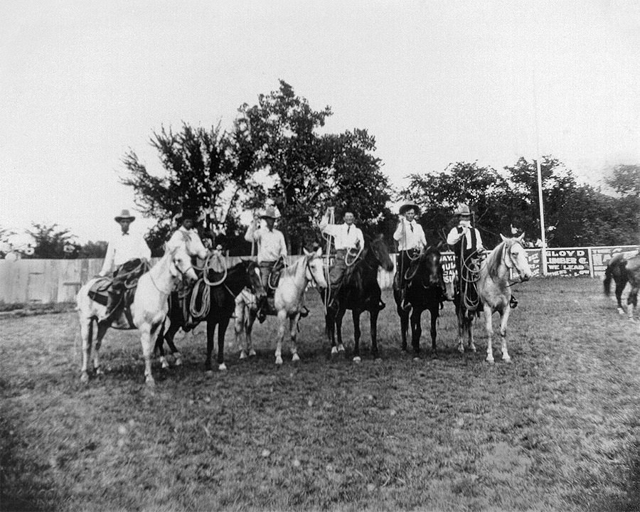 Hale (fourth from left) and Grammer (third from left) competing in a roping contest in 1909.