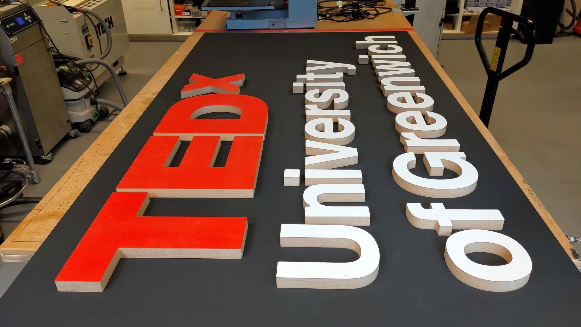View of the sign from the side, pictured in a workshop